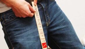 Man measuring penis with table